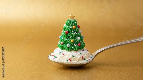 A charming mini Christmas tree dessert made with green frosting and tiny decorations, presented on a spoonful of festive, snowy ice cream on gold, decoration, festive, delightful