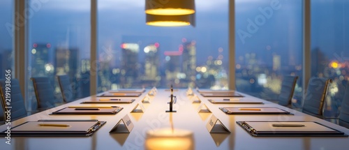 Modern Boardroom Table with City Skyline at Dusk
