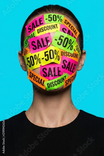 Consumerism Concept with Woman Covered in Sale Discount Stickers