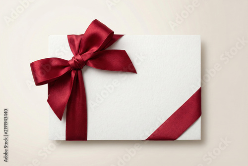 Blank Greeting Card With Red Ribbon Bow On Light Background