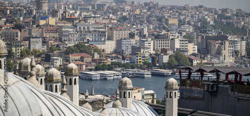 View of the Golden Horn in Istanbul, featuring historic mosque domes, passenger ferries on the water, and the dense urban skyline with the Galata Tower, Istanbul, Istanbul, Turkiye.