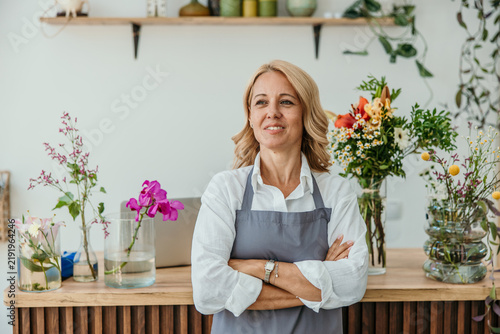 Woman florist apron standing in flower shop business