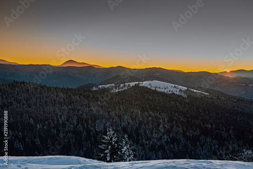 Winter sunset with a view of the Montenegrin ridge of the Ukrainian Carpathians