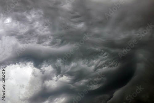 Fotografie Dark thunderclouds over the harbor and coast of Rotterdam’s Maasvlakte