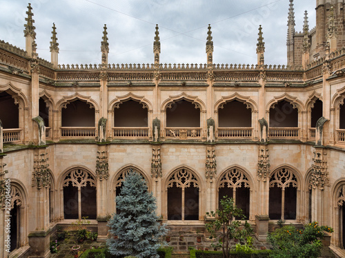 Gothic Cloister of Cartuja de Miraflores - Intricate Gothic architecture fills the cloister of Cartuja de Miraflores monastery in Burgos, Spain, showcasing historical grandeur.
