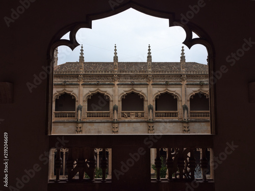 Canvas Print Ornate Arches and Balconies in Cloister - View through a dark, decorative archwa