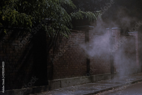 Cigarette smoke against a brick wall