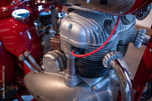 Close-up of the engine of a red vintage motorcycle.