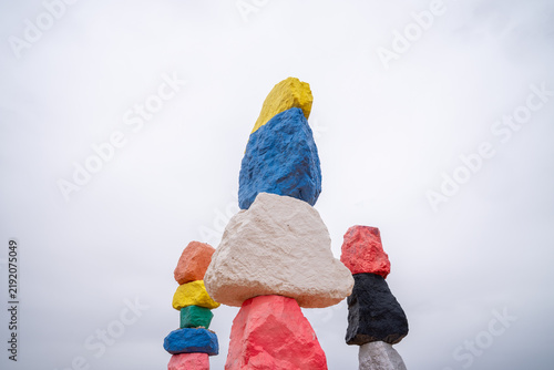 The colorful painted rocks of Seven Magic Mountains on an overcast day in the desert