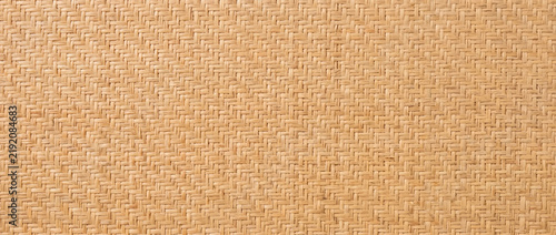 Natural rattan wallpaper with cane weave pattern. Beige woven wicker texture
