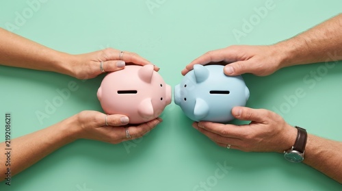 Two piggy banks held in outstretched hands for combining household budgets.