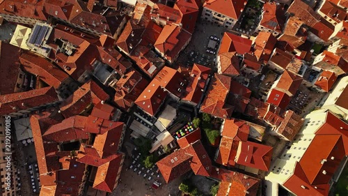 aerial top down view of dense terracotta rooftops, chimneys and narrow alleys forming an abstract pattern, useful as b roll or a textured background, kotor old town, montenegro