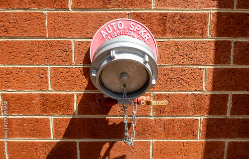 Fotografía Auto Sprinkler Fire Department Connection With 5 Storz Coupling on Brick Wall o