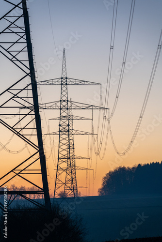 Electricity transmission towers at sunset