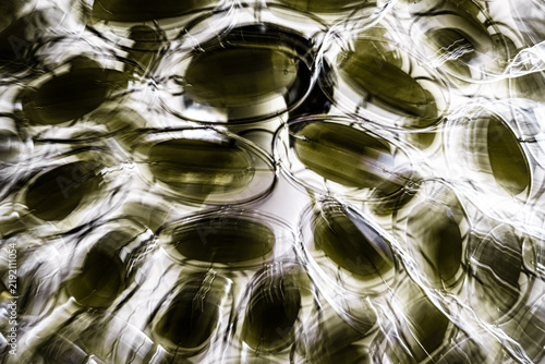 Fotografía Abstract olive green shapes and luminous trails created with intentional camera