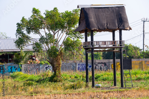 Fotografie Wooden observation watchtower hut standing in rural open field.