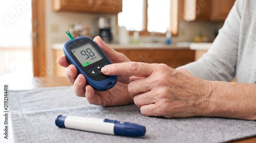 An individual diligently monitors blood glucose levels with a digital meter, a crucial daily practice for proactive health management and effective control of diabetes