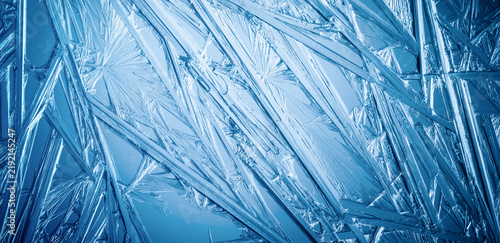 Ice frozen in intricate patterns of delicate crystals with brilliant contrast...