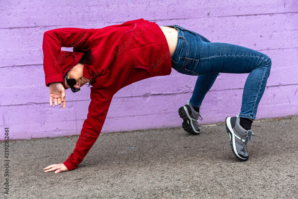 Fototapeta premium Woman performing yoga bridge pose in urban setting