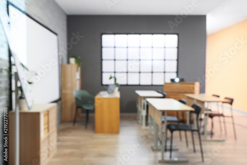 Education and classroom learning, empty school room with desks and chairs for...