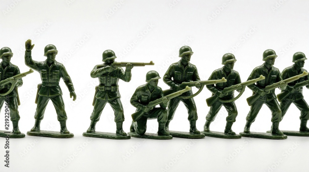 Obraz premium Line up plastic toy soldiers display various military poses and actions. Figures hold rifles engage in combat training or march formation. Group set for play reenactment or educational concept.