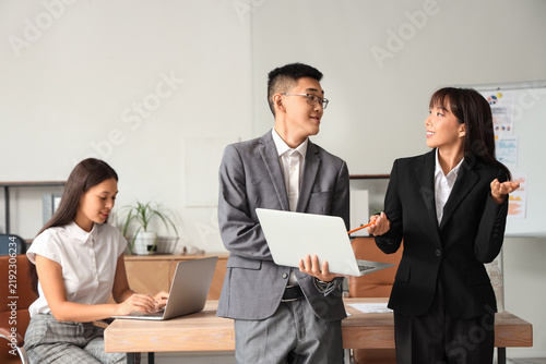 Chinese business people working with laptop in office