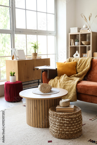 Beautiful interior of living room with brown sofa, coffee table and window