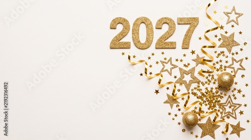 Golden 2027 New Year celebration background with stars and glitter confetti on white backdrop