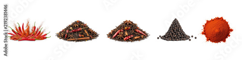 Collection of spice piles. The first pile consists of bright red chili peppers, cut into segments.