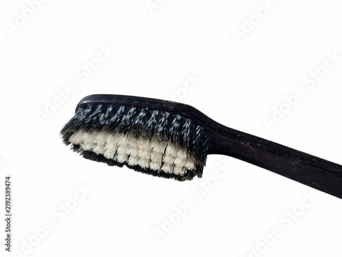 Close up of black toothbrush head with soft bristles on white background