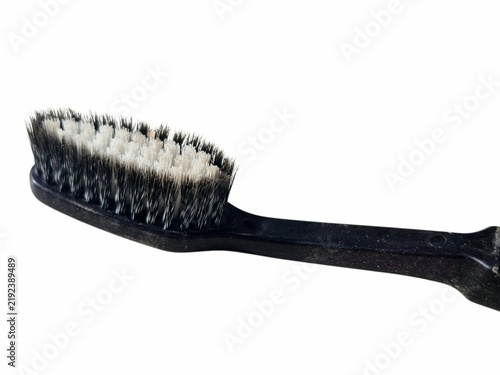Close up of black toothbrush head with soft bristles on white background