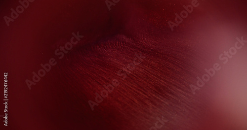 Red flow ink. Blur shimmer pigment. Glitter water pink color bright fluid shiny texture spill on abstract acrylic art background.