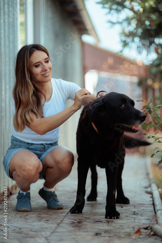 Cuadro en lienzo Woman Sneezing From Pet Allergy While Sitting Next To Her Black Dog