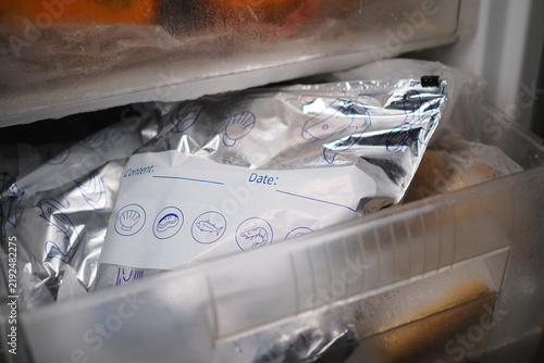 Frozen food stored in a freezer with clear labels for organization