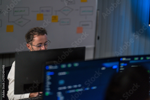 Obraz na płótnie A young male specialist walking his colleagues through live results smiles brief