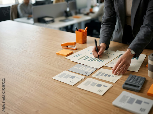 Professional Financial Analyst Reviewing Business Performance Reports and Market Trends on Office Desk