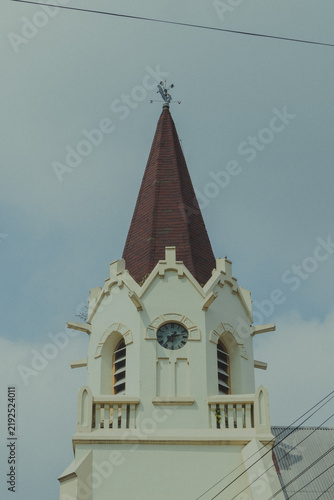 Foto Gothic Clock Tower and Weather Vane Spire of GPIB Immanuel Church in Malang, Eas