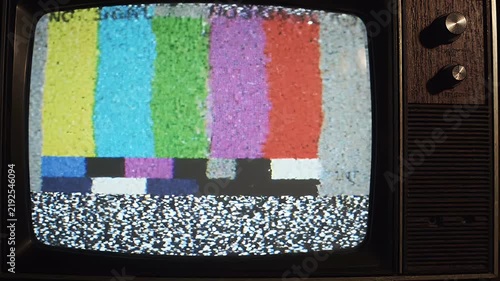 Glitchy Analog Television No Signal Test Bars - A vintage television screen displays the familiar color bars of a 