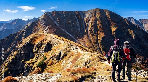 Backpackers hiking along rugged mountain trail during golden hour with clear sky or Authentic outdoor adventure scene showcasing hikers on rocky terrain.