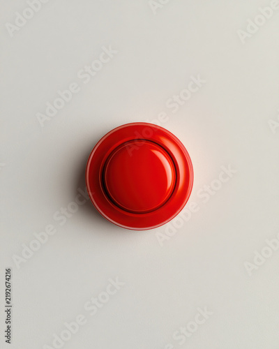 Red emergency panic button on a neutral wall, workplace safety photo  
