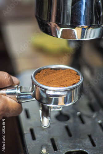 Obraz na plátně Cafe espresso grounds in a metal portafilter
