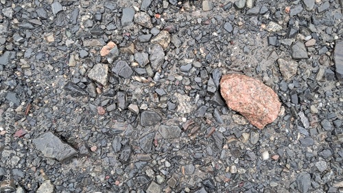 Wet Gravel Surface Texture with Red Granite Stone Top View