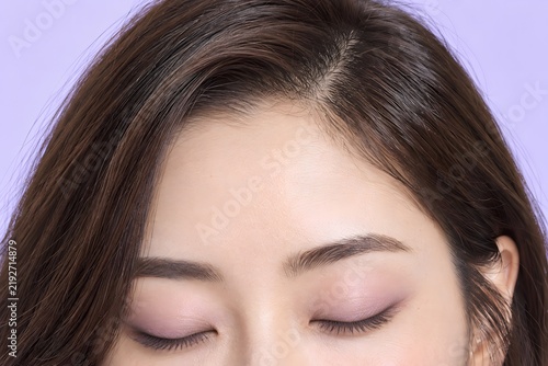 Close Up of Closed Eyes With Soft Pink Eyeshadow on Young Asian Woman Beauty Makeup
