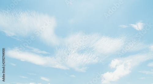 the sky is clear blue with fluffy white clouds, the sky is very bright, and the sun shines.