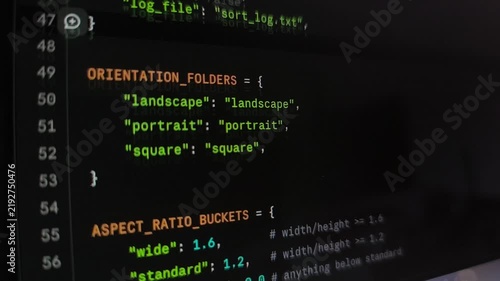 Rapid scrolling movement of colorful Python programming code text syntax on monitor. Advanced database software development compiler terminal interface layout. Digital application creation