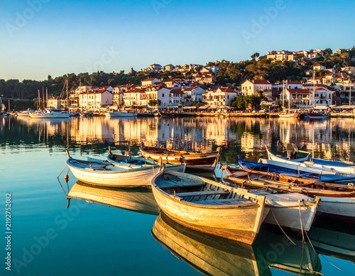 Traditional harbor filled with wooden boats, reflecting maritime culture, fishing activities, transportation, coastal life, and local heritage.