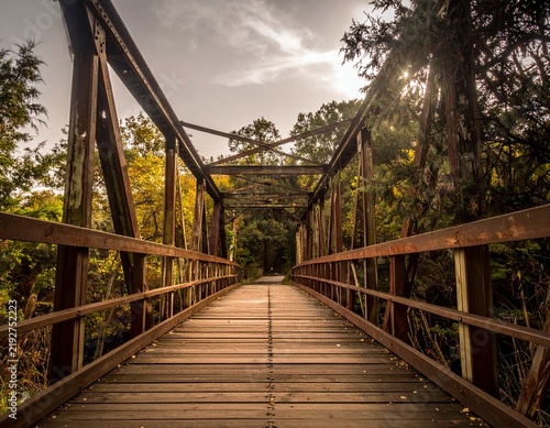 Rustic wooden bridge crossing a peaceful natural landscape, symbolizing adventure, connection, travel, and traditional craftsmanship.
