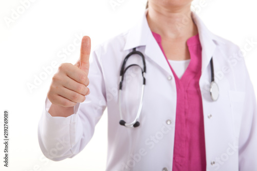 Close up of female doctor or nurse in lab coat showing thumbs up gesture isolated on white background.