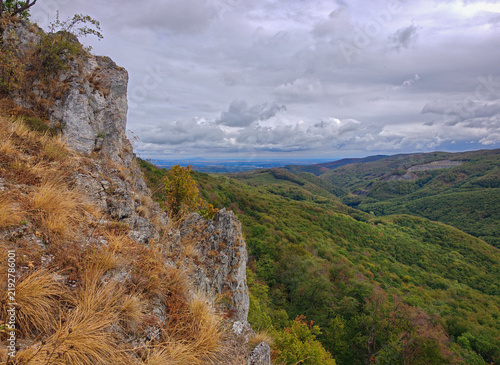 фотографія Scenic view from Magos-kő across the forested Garadna Valley toward Miskolc, with limestone cliffs and early autumn colors in the Bükk Mountains, Hungary