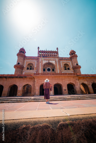 Фотография Female traveler posing in front of the historic Safdarjung Tomb in New Delhi, India